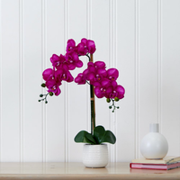 Realistic faux purple Phalaenopsis orchid with vibrant blooms and lush green leaves on tall stem