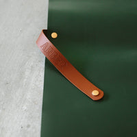 Green foldable repotting mat laid flat with plant and soil on top for mess-free repotting